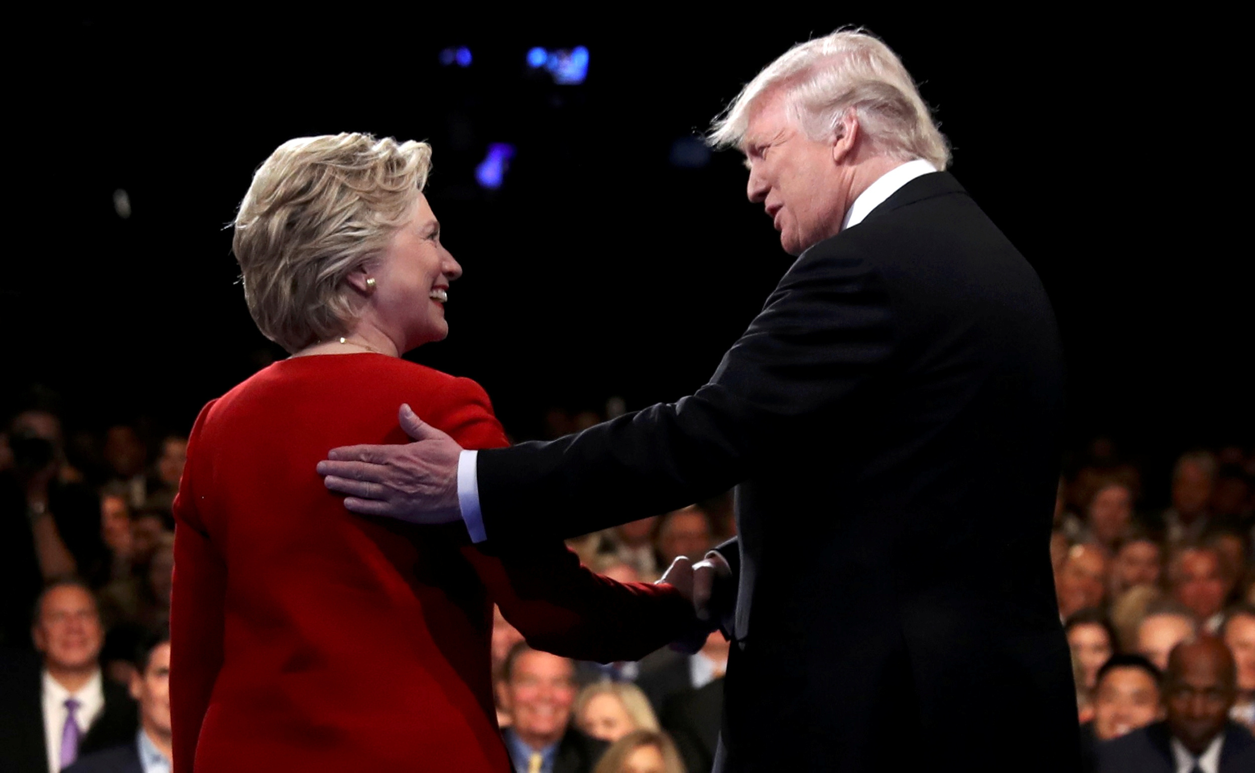 Donald Trump shakes hands with Hillary Clinton. REUTERS