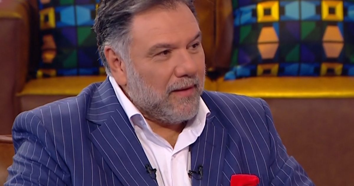 Giorgos Mazonakis sitting on a couch on a television show